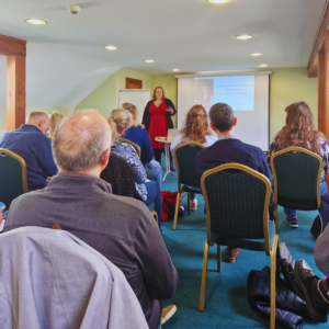 Kylie presenting in front of an audience